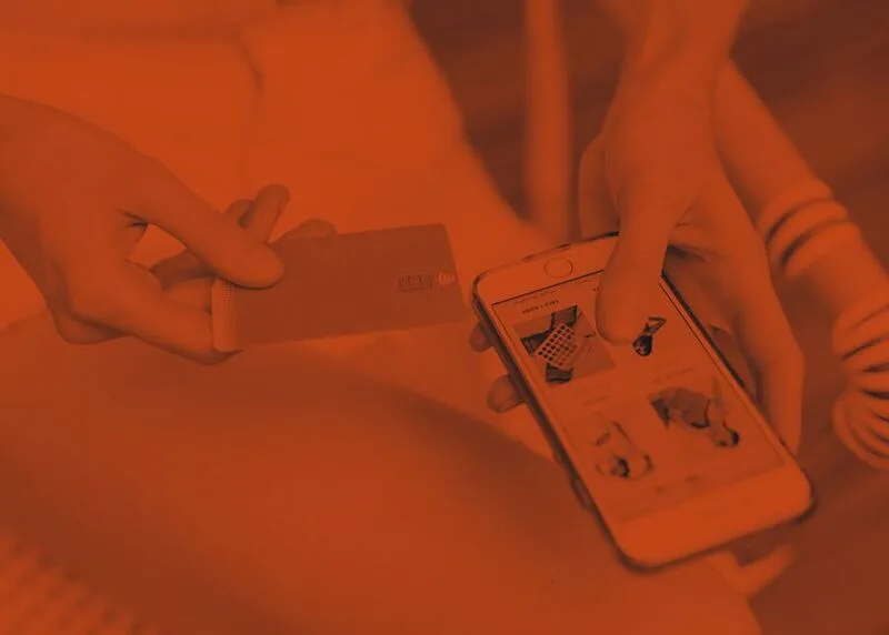 Close-up of a card-present checkout moment on a mobile storefront, mid purchase